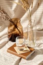 Glass of water, decorative dried flowers in vases