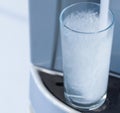 Glass in water dispenser Royalty Free Stock Photo