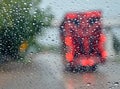 Glass water droplets. Blurred background. Road with cars. Concept. Rainy season driving on bad weather days. poor visibility feels Royalty Free Stock Photo