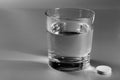 Glass of water and an effervescent pill Royalty Free Stock Photo