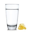 Glass of water and fish oil isolated on white background Royalty Free Stock Photo