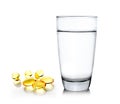 Glass of water and fish oil on white background Royalty Free Stock Photo