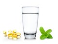 Glass of water and fish oil on white background Royalty Free Stock Photo