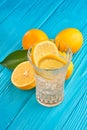 Glass of water with fresh lemon juice and ice cubes on the blue wooden table Royalty Free Stock Photo