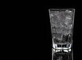 Glass with water and ice on black background, copy space Royalty Free Stock Photo