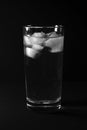 Glass with water and ice on a black background Royalty Free Stock Photo