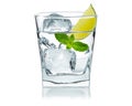 Glass of water with ice cubes, lime slice, fresh mint leaves. Cold lemonade. Frozen water in shape of cube. Ice for lime drink Royalty Free Stock Photo