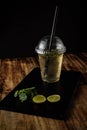 glass of water with lemon and ice on wooden background, green tea with lemon and mint, Royalty Free Stock Photo