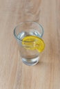 Glass with water and lemon on wooden table Royalty Free Stock Photo