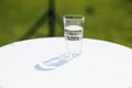 Glass of water lightened with sun on a white table Royalty Free Stock Photo