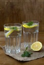 Glass of water with lime.summer drinks. two glasses of lemonade with lemon and fresh leafs mint Royalty Free Stock Photo