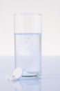 Glass of water mixed with pill Royalty Free Stock Photo