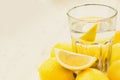 Glass of water with piece of lemon or fresh hand made lemonade Royalty Free Stock Photo