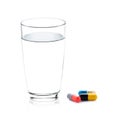 Glass of water and pills capsules