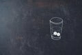 Glass of water and pills chalk drawn on blackboard. Medicine, health care and people concept Royalty Free Stock Photo