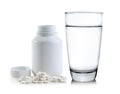 Glass of water and Pills spilling out of pill bottle Royalty Free Stock Photo
