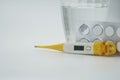 A glass of water and pills, thermometer Royalty Free Stock Photo