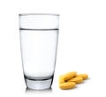 Glass of water and pills on white background Royalty Free Stock Photo