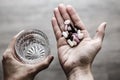 Glass of water and pills in woman hands, drug addiction Royalty Free Stock Photo