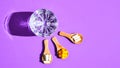 Glass of water and pills on wooden spoon on purple background with hard light and shadows. Creative. Vitamins and prebiotics,