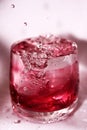 Red splashes in the glass of water Royalty Free Stock Photo