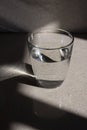 Glass of water with it\'s reflection (vertical version)