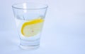 A glass of water with a slice of lemon close-up on a white background. Isolated. Space for your text Royalty Free Stock Photo