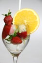 a glass of water with strawberries and an orange slice Royalty Free Stock Photo