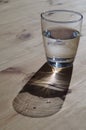 Glass with water on a wooden table