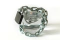 A glass of water wrapped in a chain and closed with a padlock. The concept of the problem of small drinking water resources in th