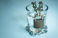 A glass of water wrapped in a chain and closed with a padlock. the problem of small drinking water resources in the world.