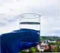 a glass of water in your hand against the sky Royalty Free Stock Photo