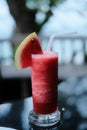 A glass of watermelon cocktail at restaurant on beach