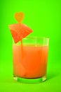 Glass watermelon fruit drink on green background