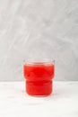 Glass of Watermelon smoothie or watermelon juice on grey background. Jus semangka Royalty Free Stock Photo
