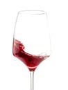 A glass with waving red wine. Isolated on white. Close-up.
