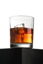 Glass of whiskey on black table isolated over white Royalty Free Stock Photo
