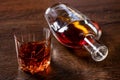 A glass of whiskey and a bottle lying on the table Royalty Free Stock Photo