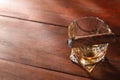 Glass of whiskey and burnt cigar on wooden table, above view. Space for text Royalty Free Stock Photo