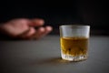 Glass of whiskey or cognac or alcohol drink, hand of a drunk man Royalty Free Stock Photo