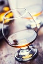 Glass whiskey cognac brandy or rum.One half full glasses of cognac on a wooden surface Royalty Free Stock Photo