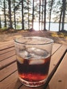 A glass of whiskey and cola with melting ice cubes on a hot summer day Royalty Free Stock Photo