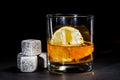 glass of whiskey with cooling stones. Dark gray bourbon stones
