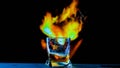 A glass of whiskey on a fiery background,an alcoholic drink on a bar counter,a cognac in a glass