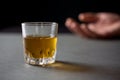 Glass of whiskey hand of a drunk man Royalty Free Stock Photo