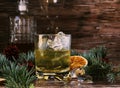 Glass of whiskey with ice, an ashtray and a decanter