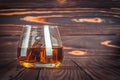 Glass of whiskey with ice, brandy on a dark brown wooden table. Bourbon. Strong alcohol drink close-up. Rum, scotch. Still life in Royalty Free Stock Photo