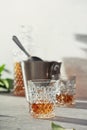 Glass of whiskey with ice cubes, ice bucket and carafe close up