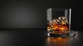 A glass with whiskey and ice cubes stands on a minimalistic black background on the left