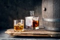 Glass of whiskey with ice decanter and barrel Royalty Free Stock Photo